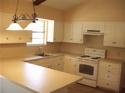 Kitchen with Breakfast Bar, Dishwasher, Stove, Vent-a-Hood, & Garbage Disposal 